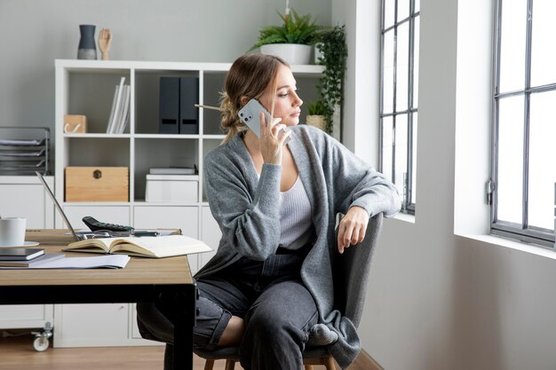 Medium shot woman talking on phone