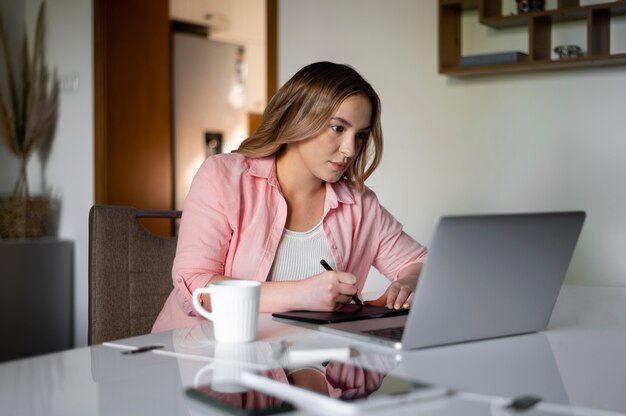 Medium shot woman teleworking