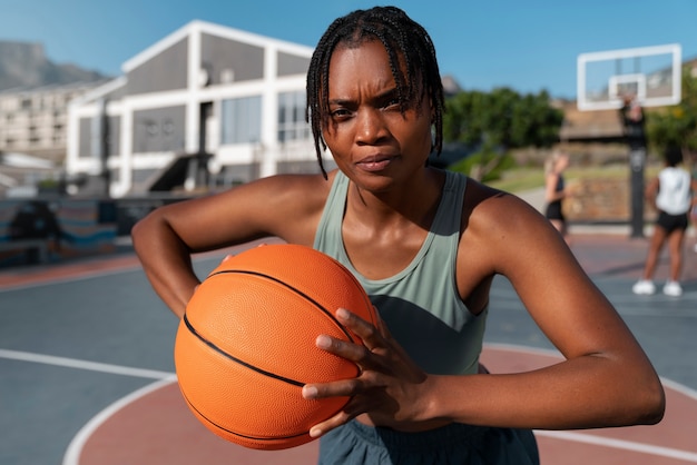 Medium shot woman training for basketball