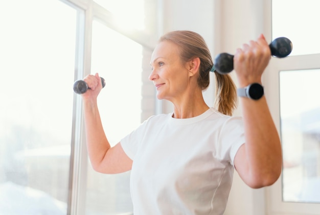 Medium shot woman training indoors