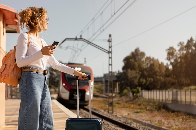 Free photo medium shot woman traveling by train