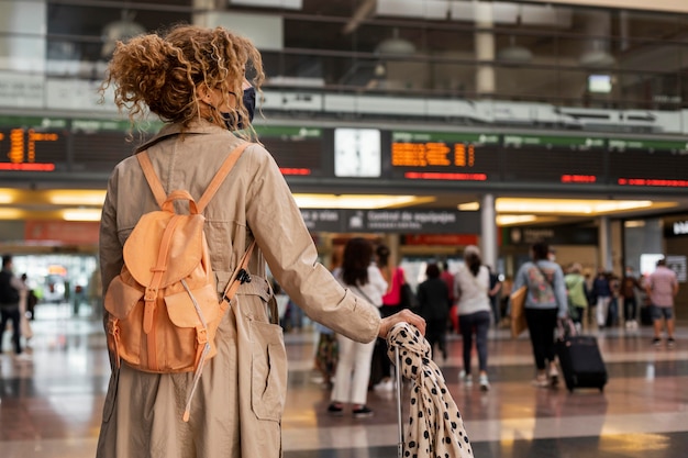 Medium shot woman traveling with mask