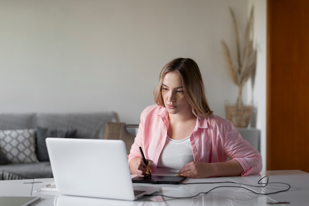 Medium shot woman using graphic tablet