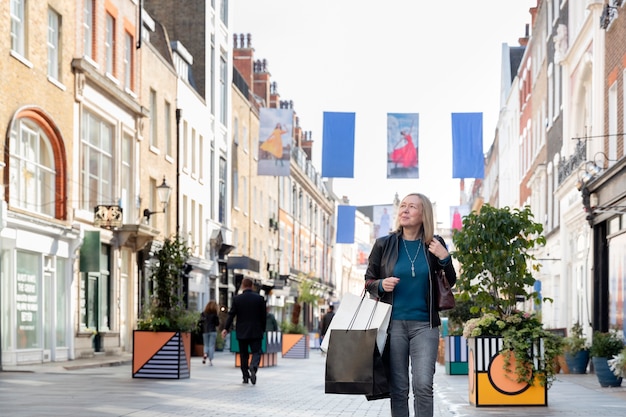 Medium shot woman walking in city