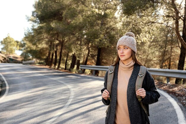 Free photo medium shot woman wearing backpack