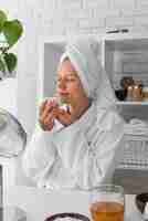 Free photo medium shot woman wearing bathrobe