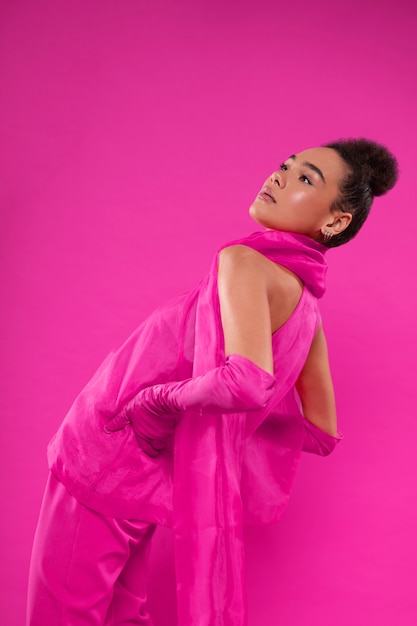 Medium shot woman wearing full pink outfit