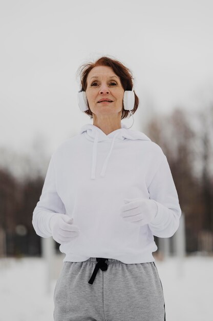 Medium shot woman wearing headphones