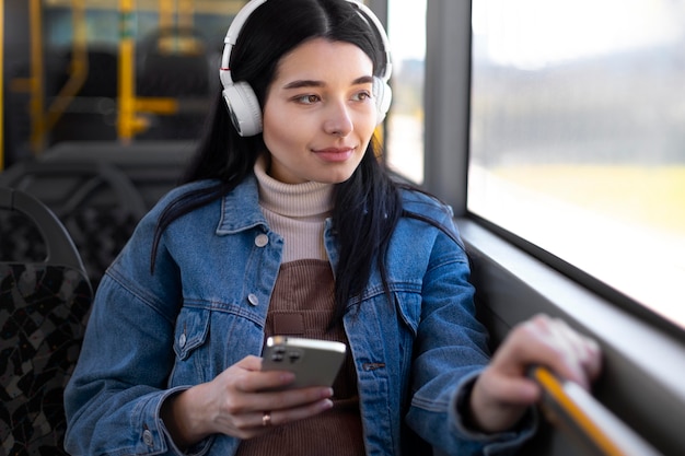 Medium shot woman wearing headphones