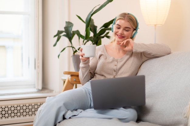 Medium shot woman wearing headphones