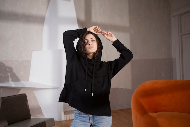 Free Photo medium shot woman wearing hoodie indoors