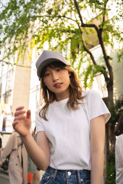 Free photo medium shot woman wearing trucker hat outside