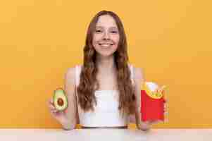 Free photo medium shot woman with avocado and fries