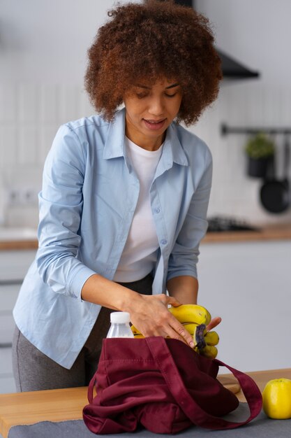 Medium shot woman with bananas