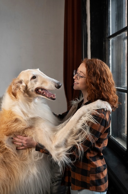 Free Photo medium shot woman with cute greyhound dog