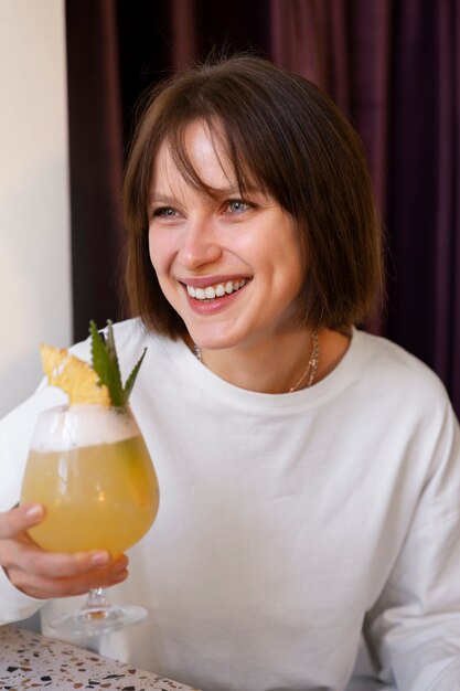 Free Photo medium shot woman with delicious cocktail