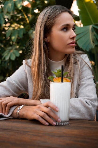 Medium shot woman with delicious pina colada