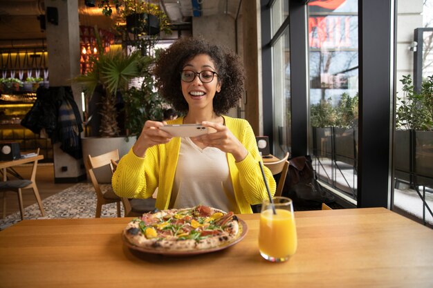 Medium shot woman with delicious pizza