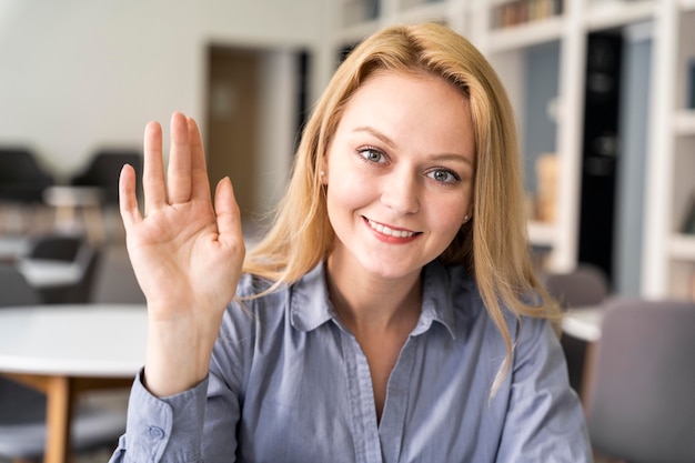 Medium shot woman with hand up