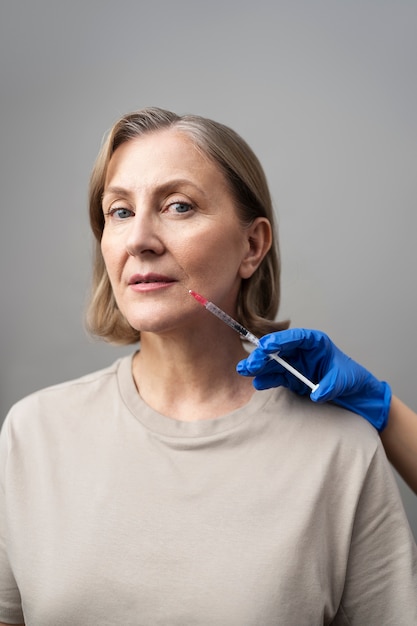 Medium shot woman with hyaluronic acid injection