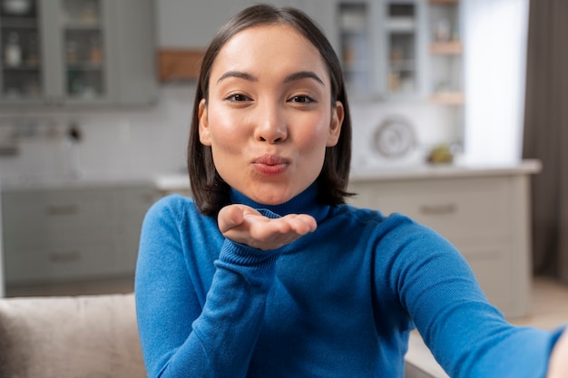 Medium shot woman with kissy face