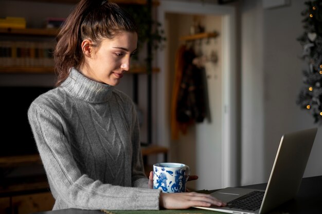 Medium shot woman with laptop