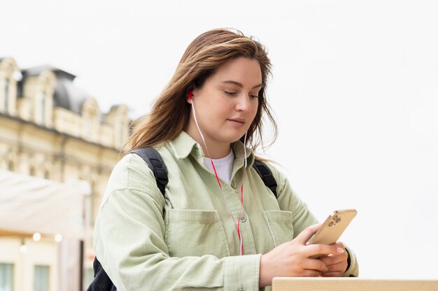 Medium shot woman with phone