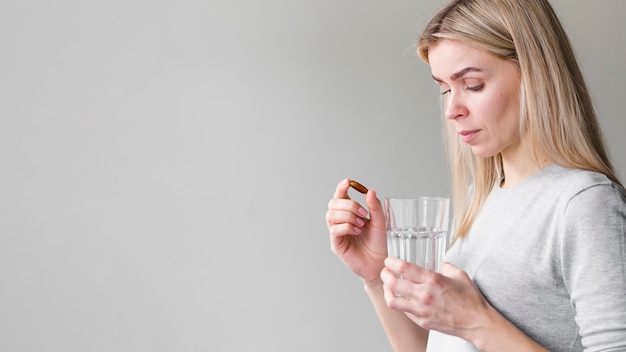 Medium shot woman with pill