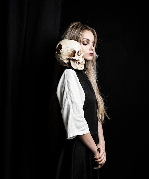 Free Photo medium shot of woman with skull on shoulder