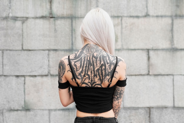 Free photo medium shot woman with tattoos on back