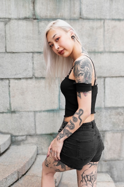 Medium shot woman with tattoos