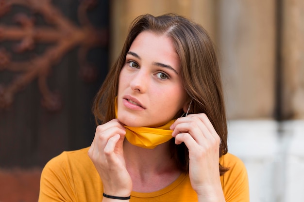 Medium shot woman with yellow mask