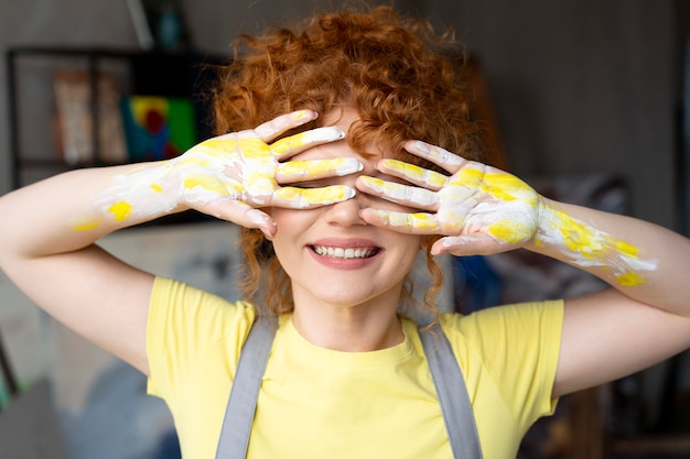 Free Photo medium shot woman with yellow paint