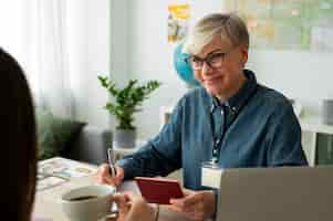 Free photo medium shot woman working as a travel agent