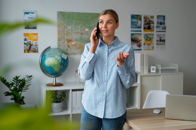 Medium shot woman working as a travel agent