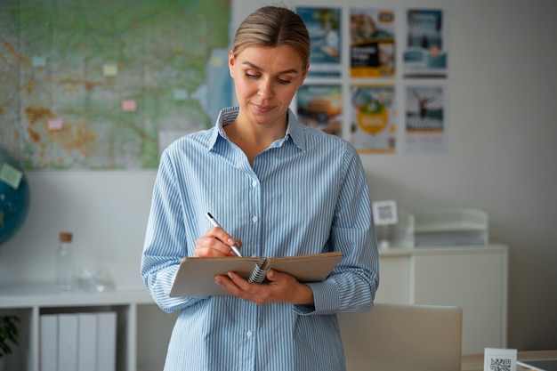 Medium shot woman working as a travel agent