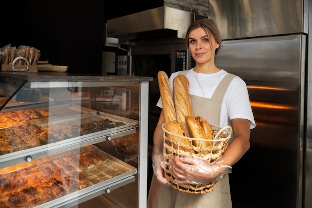 Free Photo medium shot woman working in bakery