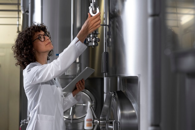 Free Photo medium shot woman working in beer factory