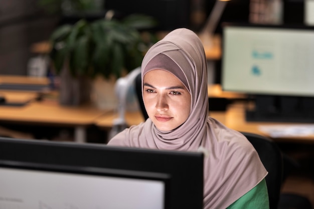 Medium shot woman working on computer