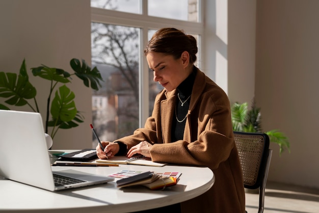 Medium shot woman working on interior design project