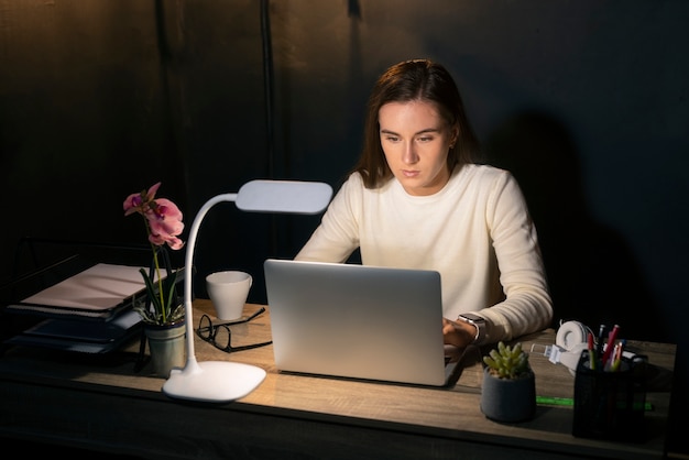 Free Photo medium shot woman working late at night