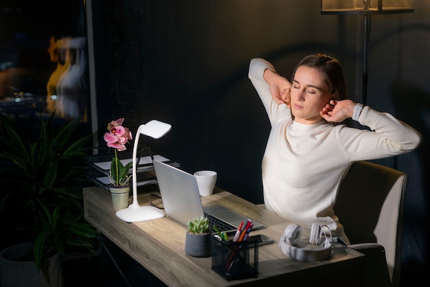 Free photo medium shot woman working late at night