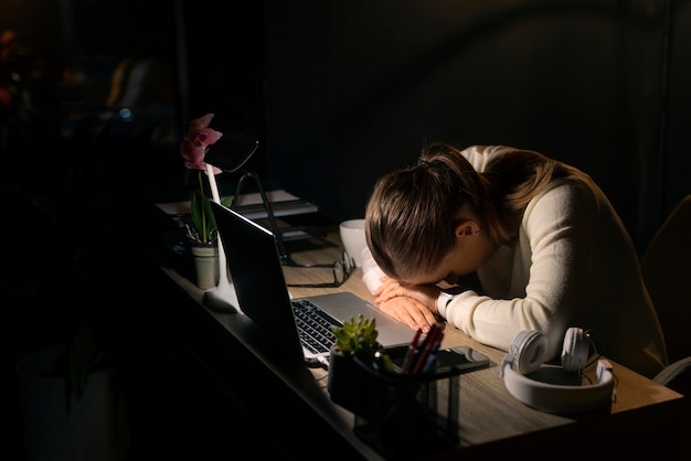 Free photo medium shot woman working late at night