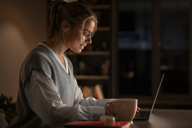 Medium shot woman working late at night