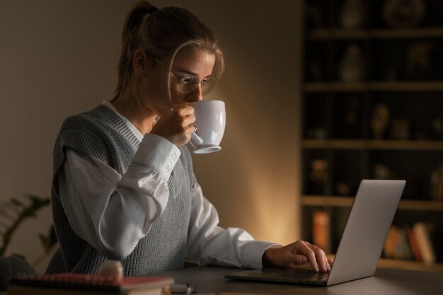 Medium shot woman working late at night