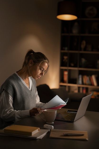 Medium shot woman working late at night