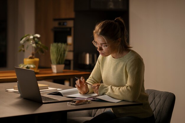 Medium shot woman working late at night