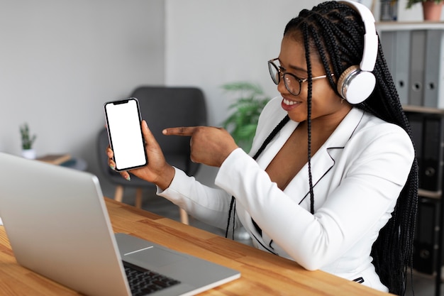 Medium shot woman working with device