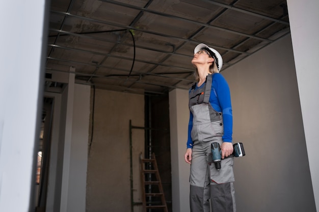 Free Photo medium shot woman working with drill