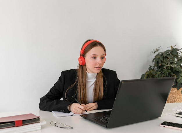 Medium shot woman working with headphones